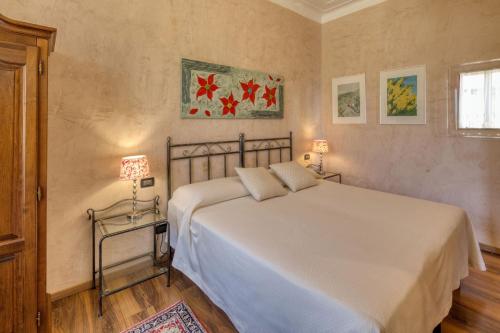 热那亚梦德娜洛坎达别墅酒店的卧室设有一张白色大床和一扇窗户。