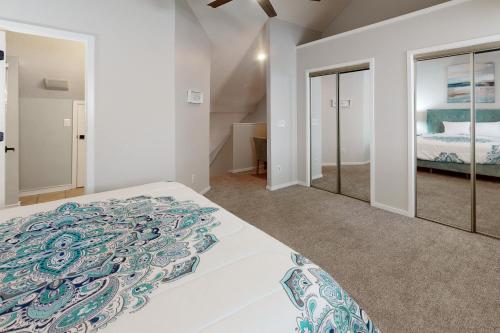 利特尔里弗Beach Golfer's Nest的白色卧室配有床和镜子