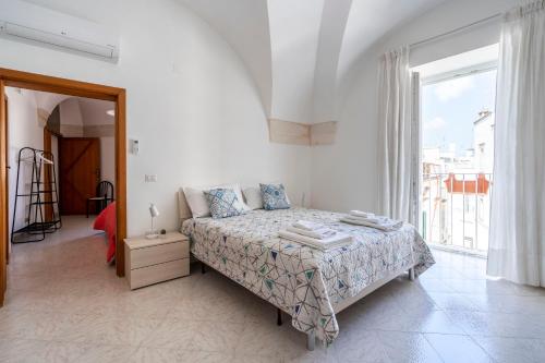 马丁纳弗兰卡Typical Apulian Apartment的一间卧室设有一张床和一个大窗户