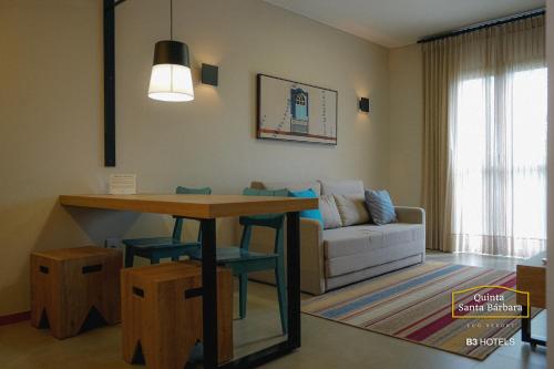 皮雷诺波利斯Resort Quinta Santa Bárbara OFICIAL的客厅配有桌子和沙发