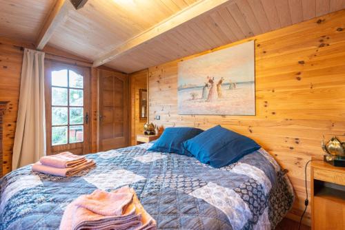 索斯佩勒Eco Chalet , Grande Terrasse的卧室配有木墙内的一张床