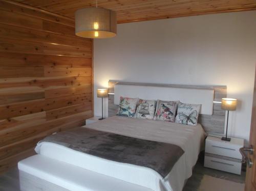 辛特拉Casa do Morro的卧室配有白色的木墙床