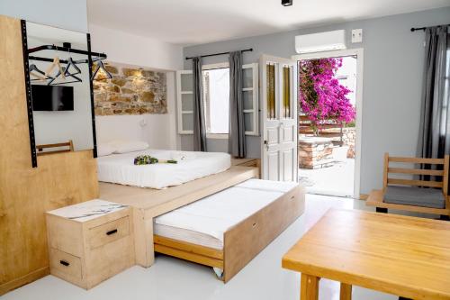 埃尔莫波利斯Axilleion Guest House的一间卧室配有两张床和一张桌子