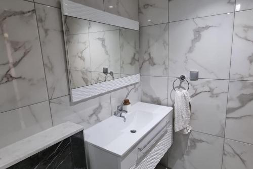 莫纳斯提尔Fantastique, luxerieux, agreabel appartement的白色的浴室设有水槽和镜子