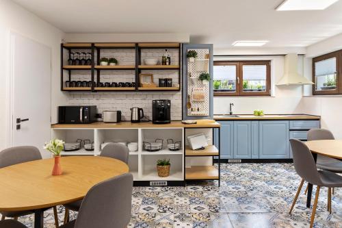 锡比乌6Rooms的厨房配有蓝色橱柜和桌椅