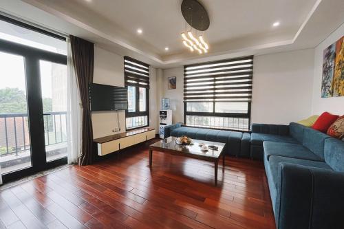 河内Hanoi Home 8 - Luxury Apartment, open view的客厅配有蓝色的沙发和桌子