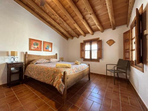 阿拉哈尔Campanario 3的一间卧室设有一张床和木制天花板