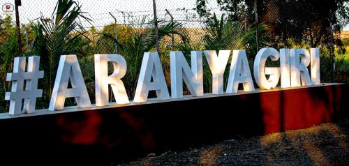 浦那Aranyagiri Countryside Resort, Near Pune的一个大的标志,上面写着“maranazi”