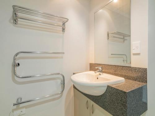 怀蒂昂格Marinaview - Whitianga Holiday Apartment的一间带水槽和镜子的浴室