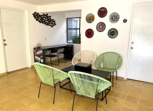 拉巴斯Villa Esterito的一间餐室,墙上摆放着椅子和桌子及盘子