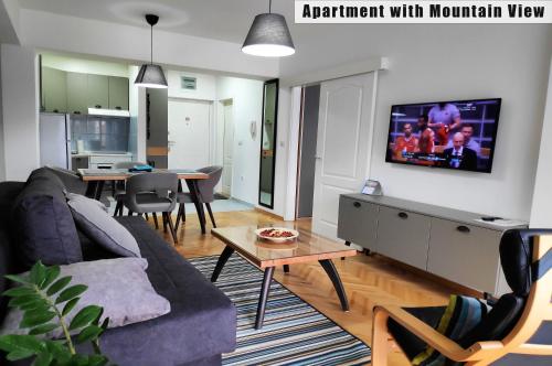 奥赫里德Apartments FANTASY的客厅配有沙发和墙上的电视