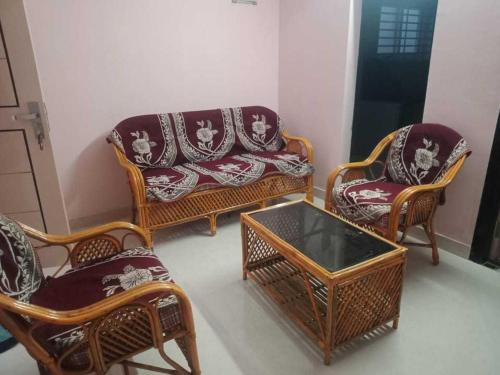 拉加蒙德里OYO HOME 81185 Srinivas Service Home的客厅配有椅子、沙发和桌子