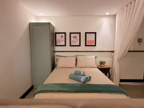 拉古纳Residence Farol - Loft 204的一间卧室配有一张床,上面有两条毛巾