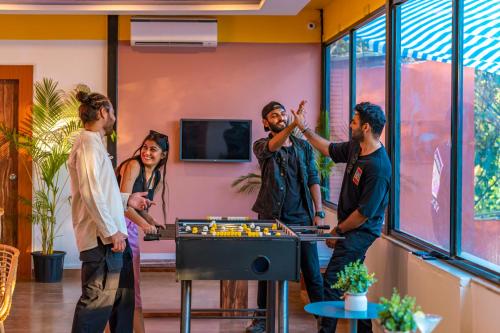 阿伯来The Hosteller Goa, Arpora的一群人在房间里玩电子游戏
