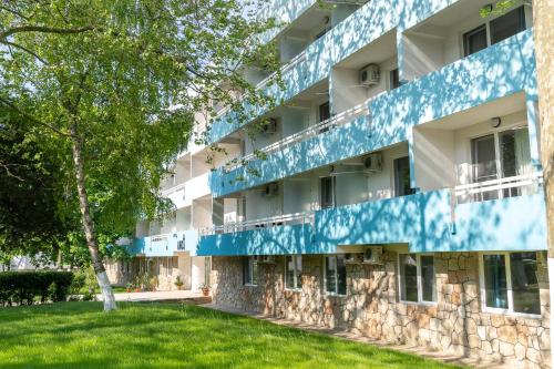 维纳斯Mera Holiday Resort的公寓大楼拥有蓝色和白色的外墙