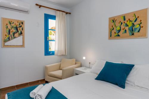 赫索尼索斯伊莱尼别墅酒店的一间卧室配有一张床和一把椅子
