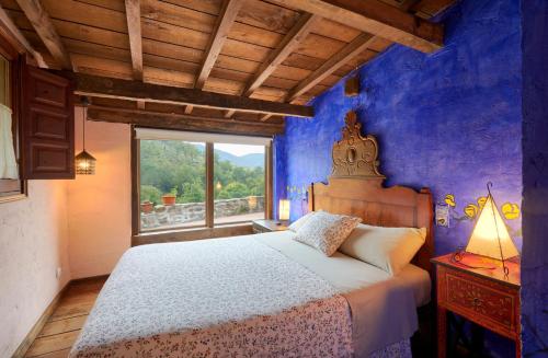 圣胡安-德拉斯阿巴德萨斯Galliner, El Reixac Casa Rural的一间卧室设有一张大床和一个窗户。