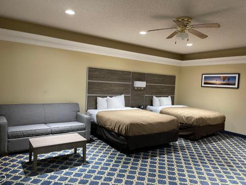 ThomasvilleQuality Inn Thomasville-Northpark的酒店客房,设有两张床和一张沙发