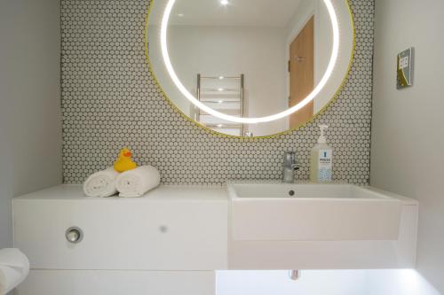 费勒姆索伦特酒店的浴室设有白色水槽和镜子