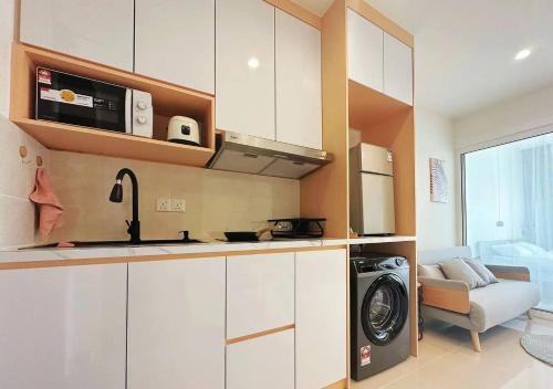哥打京那巴鲁Summer Studio Apartment at Kota Kinabalu City Centre的一间厨房,在房间内配有洗衣机和烘干机
