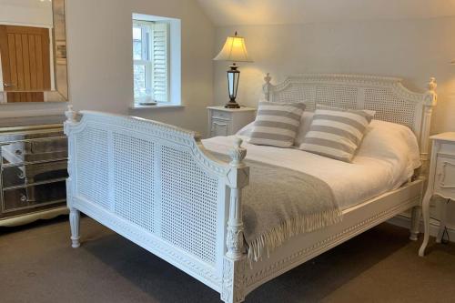 圣艾夫斯Folly Farm Cottage, Cosy, Secluded near to St Ives的卧室配有带枕头的白色床
