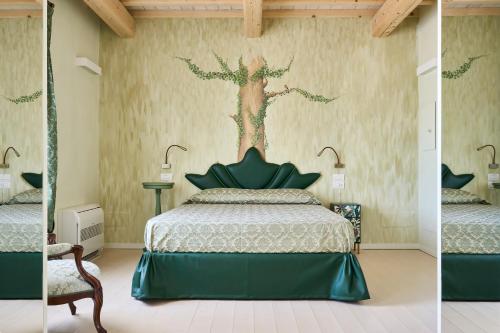 里米尼Agriturismo Borgonuovo的卧室配有一张床,墙上有一棵树