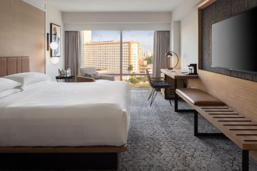 圣胡安Sheraton Puerto Rico Resort & Casino的配有一张床和一台平面电视的酒店客房