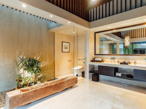 坎古Ametis Villa -Adult Only的一间带大浴缸和大镜子的浴室