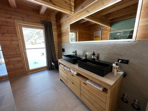 考恩台尔Chalet Chardonnay的一间带两个盥洗盆的浴室和一个大窗户