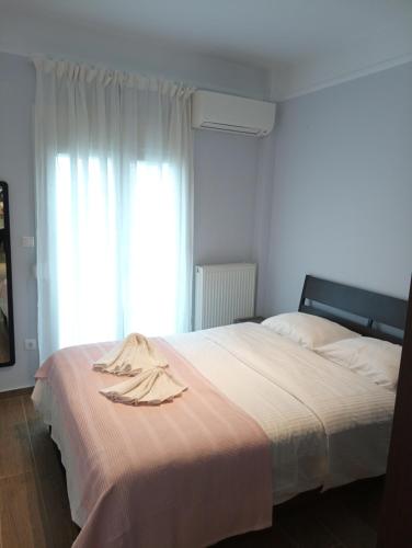 塞萨洛尼基Kalamaria brand new 1 bedroom apartment的一间卧室配有一张床,床上有浴袍