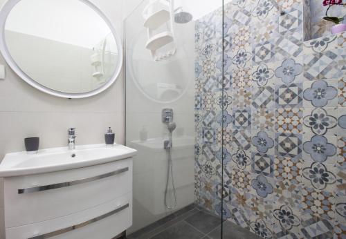 斯普利特Split Urban Getaway的浴室配有盥洗盆和带镜子的淋浴