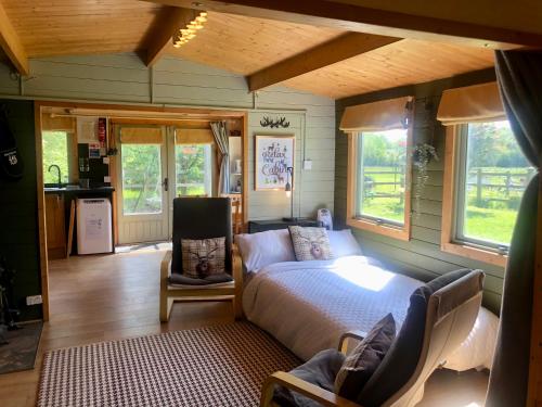 乌波斯顿Mulberry Cottage Farm的一间卧室,卧室内配有一张床和一把椅子