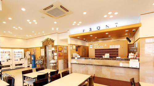 带广Toyoko Inn Hokkaido Tokachi Obihiro Ekimae的一间带桌椅和柜台的餐厅