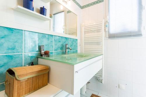 居让梅斯特拉Bassin Arcachon, Mais. 3 étoiles, spa, 500 m plage的浴室设有水槽和蓝色瓷砖