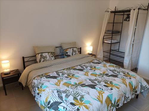 萨兰莱班O'Couvent - Appartement 66 m2 - 2 chambres - A523的一间卧室配有一张带五颜六色棉被的床