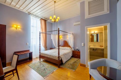 埃尔莫波利斯阿波罗尼奥皇廷酒店的一间带天蓬床的卧室和一间客厅