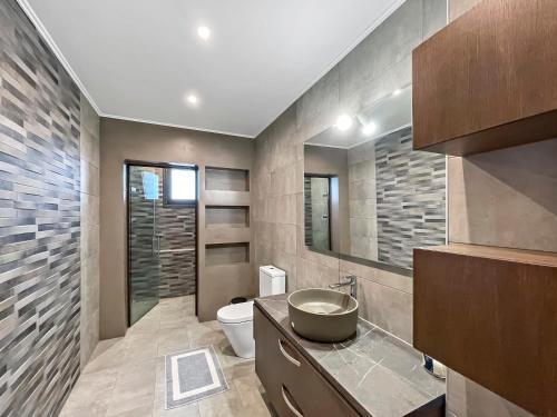 沃尔沃罗Luxury rental villa for 14 people的一间带水槽和卫生间的浴室