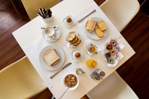 比雷埃夫斯Anemoni Piraeus Hotel的一张带早餐食品的白色桌子