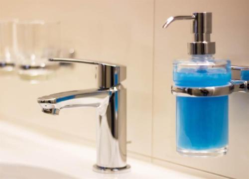 圣加伦基希Haus Gant的浴室水槽上坐着一瓶蓝色肥皂