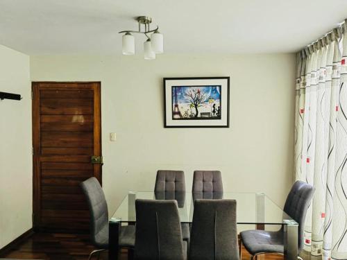 特鲁希略Hermoso Apartamento en el Centro de Trujillo的一间设有玻璃桌和椅子的用餐室