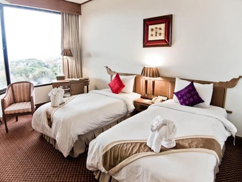 乌汶莱丝翁酒店的酒店客房设有两张床和窗户。