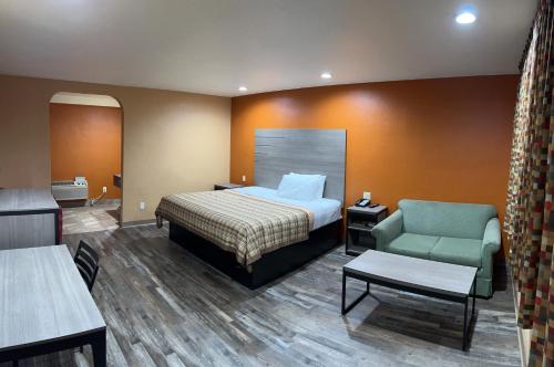 莫德斯托顶点旅馆的配有一张床和一把椅子的酒店客房