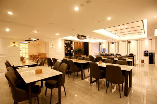 釜山西亚特B酒店的一间在房间内配有桌椅的餐厅