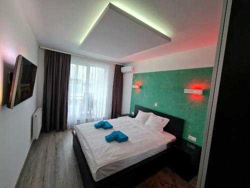 克卢日-纳波卡Cluj CITY Vibe的一间卧室配有一张带2条蓝色毛巾的床