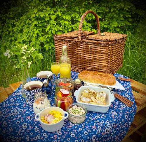 Maringotka Za Trnkou的一张野餐桌,上面有一篮子的食物和面包
