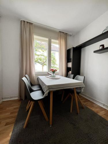 汉诺威1 Room Apartment in City of Hannover的一间带桌椅和窗户的用餐室