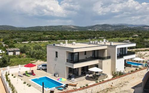 希贝尼克Villa Adriatic Sunrise的一座大房子,前面设有一个游泳池