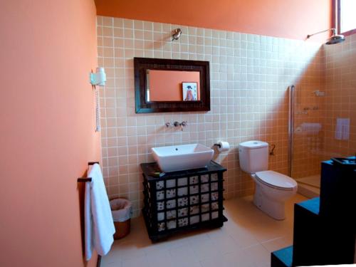 卡兰特萨盖鲁勒谭旅馆的一间带水槽、卫生间和镜子的浴室