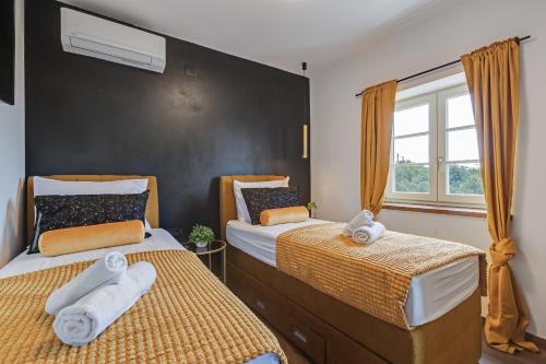 萨利TEONA Luxury Apartment with 2 rooms and terrace sea view的一间卧室配有两张带毛巾的床