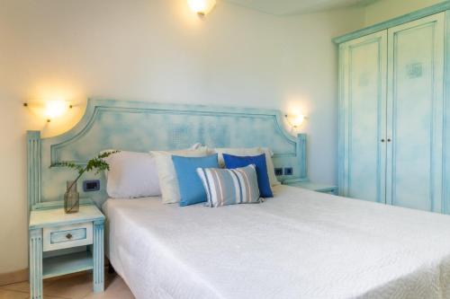 卡尔德杜Museddu Beach Residence的蓝色卧室配有一张带枕头的大床